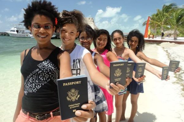 (L to R) Teen travelers Jazmyne, Daizia, Shannon, Soleil, Viviana and Lyanna show off their very first passports on their very first international adventure to Belize, Central America via The Passport Party Project